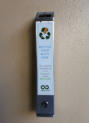 Long narrow receptacle with label indicating that butts placed inside will be recycled