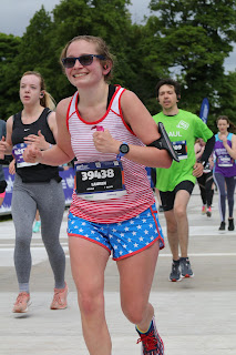 Me smiling holding a gel pack as I finish the race.