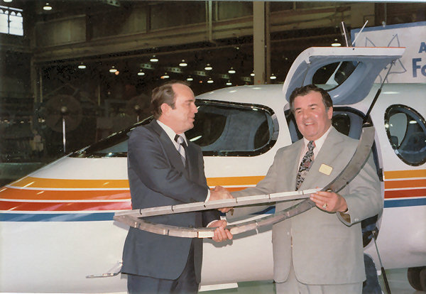 George Irwin from Aeronca hands over the first Foxjet manufactured part to Tony Fox
