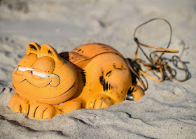 Spare parts of plastic 'Garfield' phones are displayed on the beach in Plouarzel, western France, after being collected from a sea cave by environmental activists.