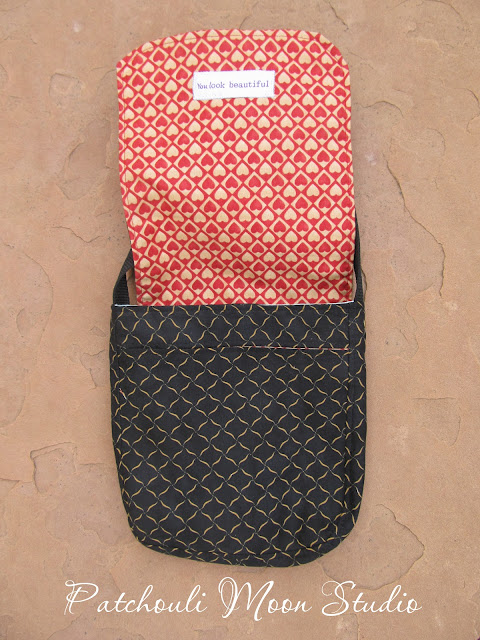 Flap up to show the lining flap and front of purse