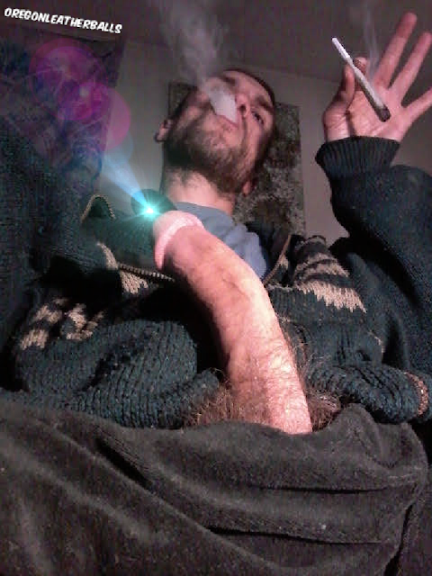 Smoking a spliff with hard big cock out blowing clouds upward