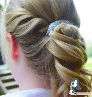 Image description: Add some hairspray or other styling products to finish the look, and consider adding accessories such as a hair clip or headband.
