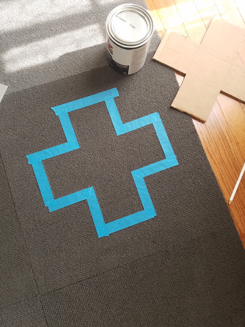 cross area on rug taped with blue tape