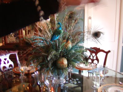 My centerpieces will be peacock feathers with Gold and Taupe shiny balls