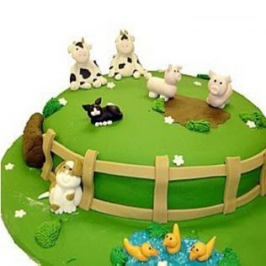 green cake decorated with animals