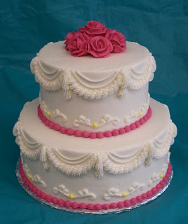 2 tier pink and white wedding cake with pink roses