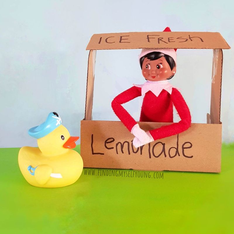rubber duck at lemonade stand with elf on the shelf