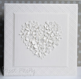 White on white card featuring heart made of tiny flowers