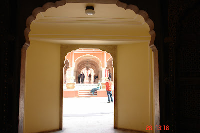 Photo of a view through a doorway, and into a bright courtyard