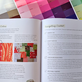 The Quilter's Frield Guide to Color book open with color swatches in the background