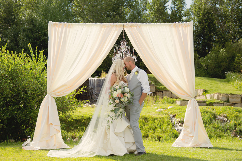 Bride and Groom / Ceremony Arch / Flowers by Mac's Floral / Photography: Tracy Moore Photography