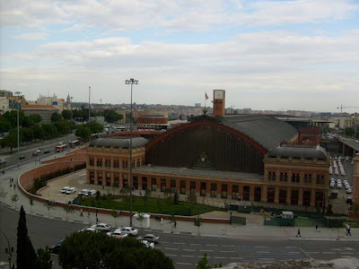 Madrid Atocha (Spanish: Estación de Madrid Atocha, also named Madrid Puerta de Atocha) is the largest railway station in Madrid. It is the primary station serving commuter trains (Cercanías), intercity and regional trains from the south, and the AVE high speed trains from Barcelona (Catalonia), Saragosse (Aragon), Seville (Andalusia) and Valencia (Levante Region). These train services are run by the Spanish national rail company, Renfe. The station is in the Atocha neighborhood of the district of Arganzuela. The original façade faces the Plaza del Emperador Carlos V, a site at which a variety of streets converge, including the Calle de Atocha, Paseo del Prado, Paseo de la Infanta Isabel, Avenida de la Ciudad de Barcelona, Calle de Méndez Álvaro, Paseo de las Delicias, Paseo de Santa María de la Cabeza, and Ronda de Atocha.