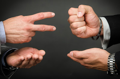 2 pairs of hands are showing the age-old game of rock-paper-scissors