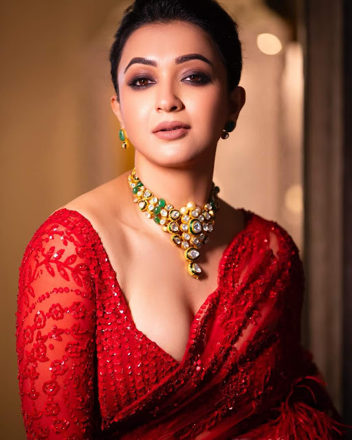 Koushani Mukherjee looking ravishing in a red saree, showcasing her hot photoshoot stills with confidence and grace.