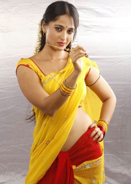 Anushka Yellow Saree Pics showing Back with Romantic Pose