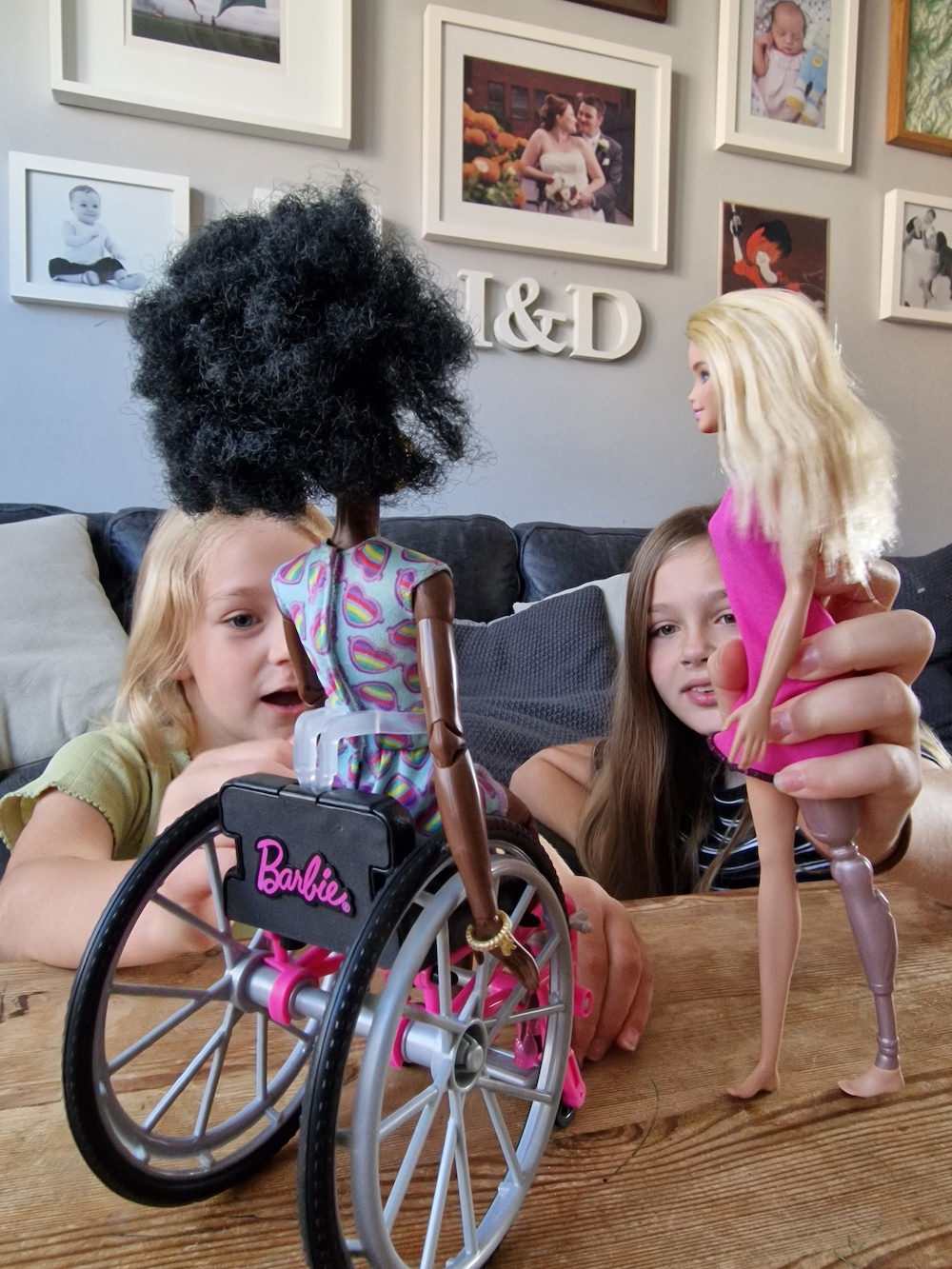 Barbie in a wheelchair and barbie with prosthetic leg