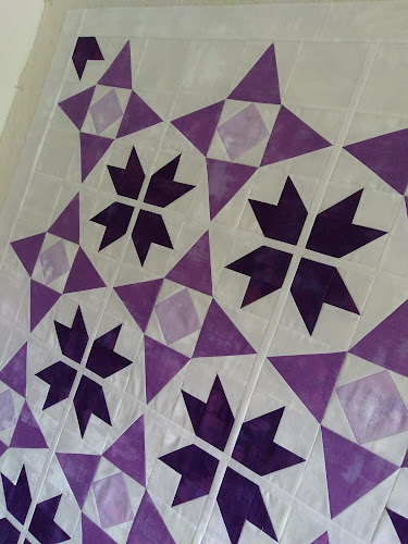 Partial quilt top with stars in 3 shades of purple