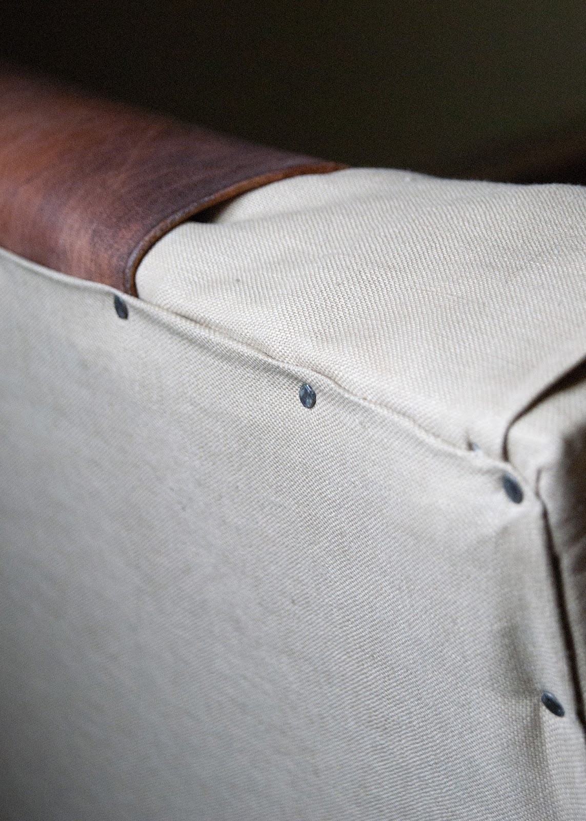 Close up of detail - leather, linen and nailheads. 