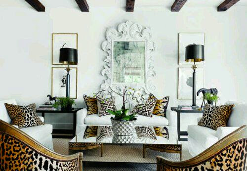 white living room with leopard print chair gold mirror accents