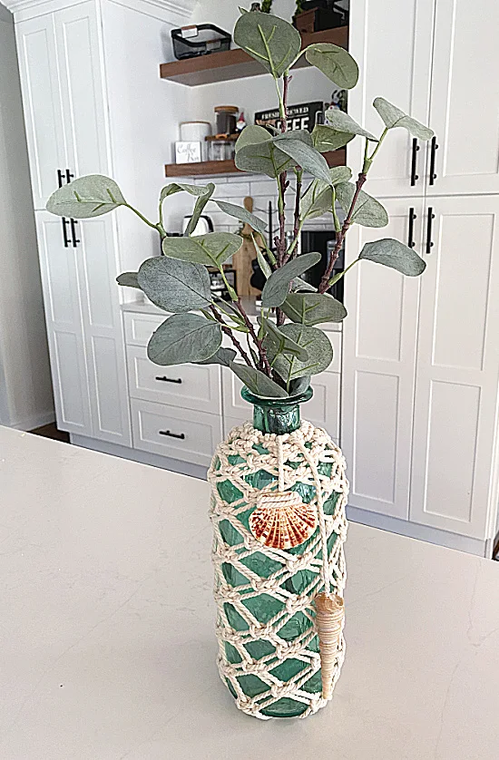 macrame vase with shells and greens