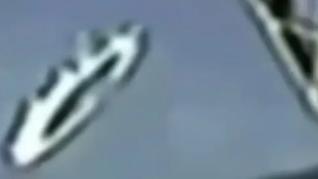 A round Prometheus shaped UFO comes out from behind a SpaceX rocket in higher Earth atmosphere.