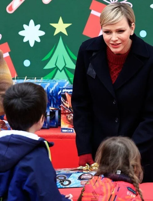Princess Charlene is wearing the Emory jumper by Emilia Wickstead, and the Princess is wearing an Akris navy blue coat