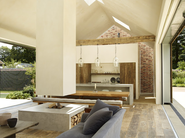 farmhouse table with long benches with trufted cushions, floating fireplace