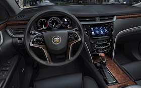 2013 Cadillac XTS interior, black with wood accents, CUE touchscreen and reconfigurable gauge cluster