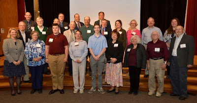 Group photo of volunteer of the year honorees on stage of State Museum auditorium