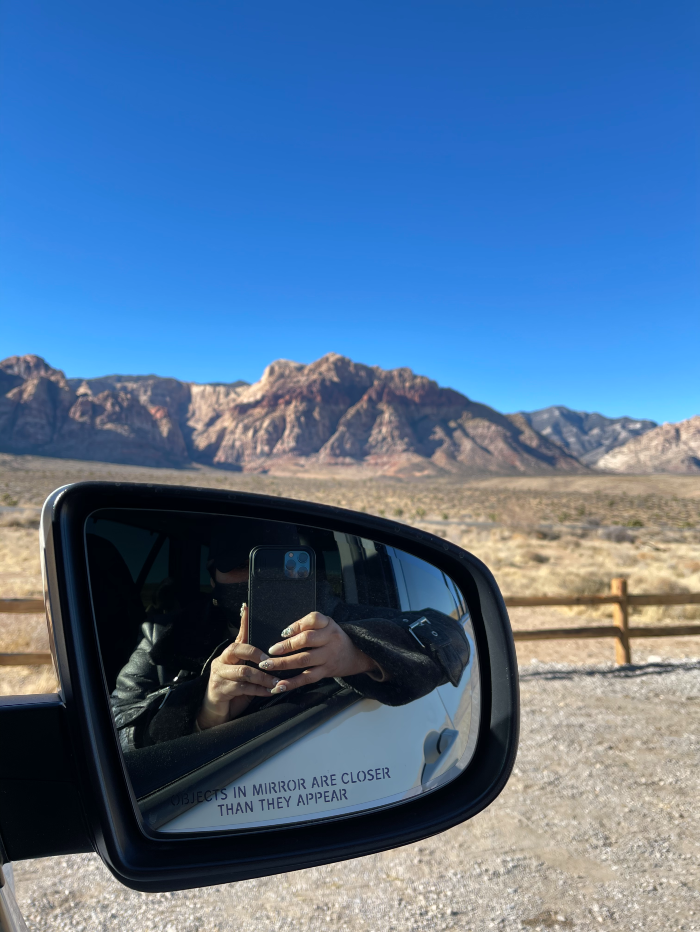 woman sitting in a car while traveling in the mountain