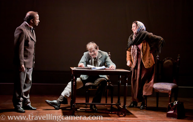 I hope you have already checked pre-interval stories from 'Chekhov ki Duniya', if not check out following link to know about this play and first three stories - http://www.travellingcamera.com/2011/12/chekhov-ki-duniya-part-1-nsd-play.htmlNext three stories are here...4th story from Chekhov ki Duniya was - Besahara Aurat, although story tells something else :)'Besahara Aurat' features a wild woman with a nervous disorder who tries to extort money from a banker.Cast of Besahara Aurat included - Aurat played by Rajini, Bank manager played by Kailash Chauhan, Pochetkin role played by Anirudh Wankar...Rajni and Kailash were two main actors in this story and both of them were awesome !!!'Dooba Hua Aadmi', a man in the 'maritime entertainment business' will drown himself for a small fee. This is only photograph I could click during this story due to extremely low light on stage. Cast of this story included :: Aadmi played by Anirudh Wanker, Writer played by Sunil Upadhyay, Policemen by Prasanna Soni...'The Gift' is a tale of a dedicated father who thrusts his shy, 19-year old son into manhood by taking him to a house of ill repute, only to relent at the last moment and leave the boy more perplexed than ever.Rajni played the role of a prostitute in this story and main conversation happened between Rajni and Deep, who was Father of the birthday boy.Here is a seen when a dad to talking to a prostitute for his son. Conversation was more about negotiation and some thoughtful things around the relationship of a son & father...Finally father realized that it was not a good gift for his son and came back to market to find something useful...With this story, Chekhov ki duniya ended with lots of noise in the auditorium... Everyone was really happy after the show...Prasanna Soni and Madhumita !!!Rajni and Deep Kumar !!!Kailash Chauhan & Jawed !!!Sunil Upadhayay - as Chekhov !!!