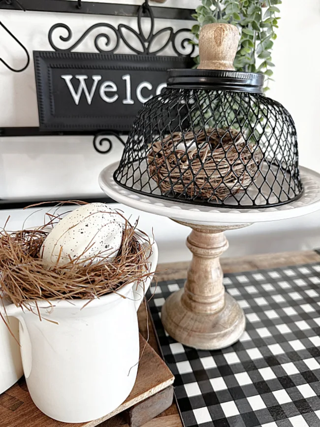 cloche with nest on pedestal