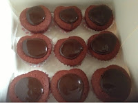 heart shaped red velvet cupcakes with chocolate topping 