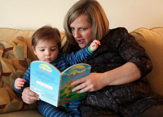 Image: Lynne Adams reads a story to her little boy, Anderson Adams, before bedtime. Lynne is now pregnant with her second child.