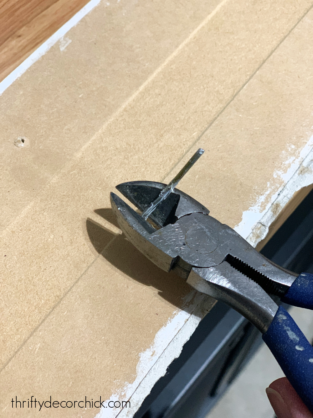 removing nails with pliers