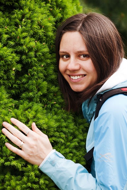 young woman hugging tree