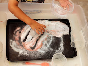 Child playing with magic fizzy "sand"