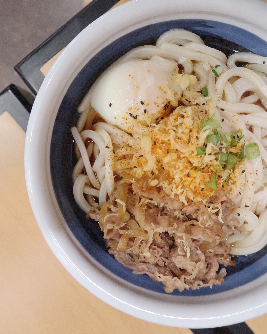 A close up shot of Marugame Udon's Nikutama udon bowl with al dente-style noodles.