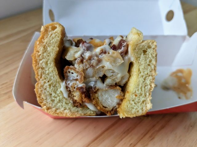 Jack in the Box Spicy Sauced & Loaded Chicken Sando cross-section.