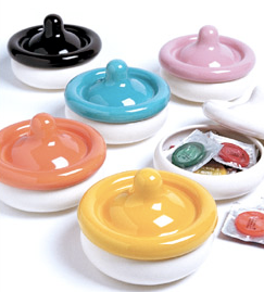 white pots with colorful lids shaped like condoms; one shown as storing condoms inside