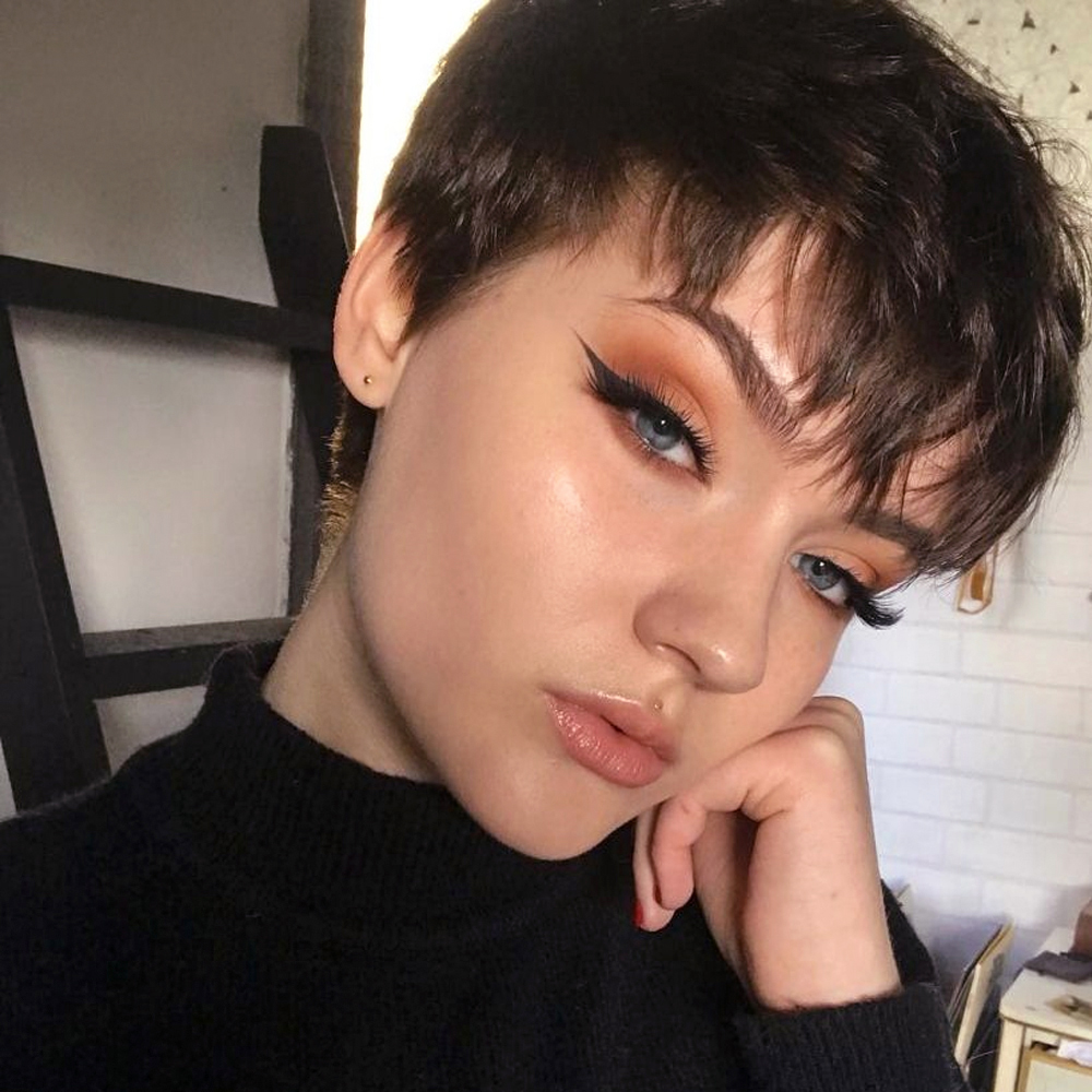 selfie of a young woman with beautiful makeup and short pixie cut