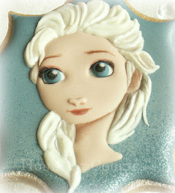 Finished handpainted decorated cookie of Elsa from Disney's Frozen, by Honeycat Cookies