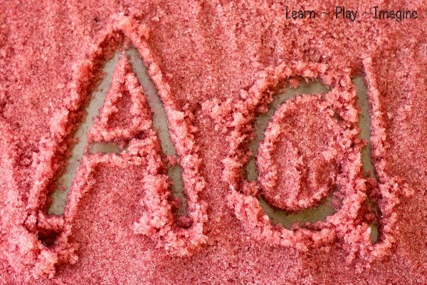 Writing practice on an apple cinnamon learning tray