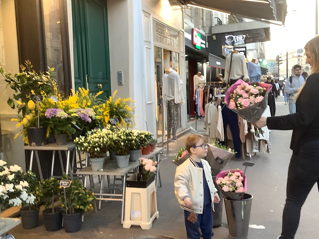 Mom shows pink bouquet to her little son