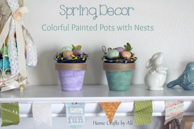 colorful painted terra cotta pots with nests in spring decorations