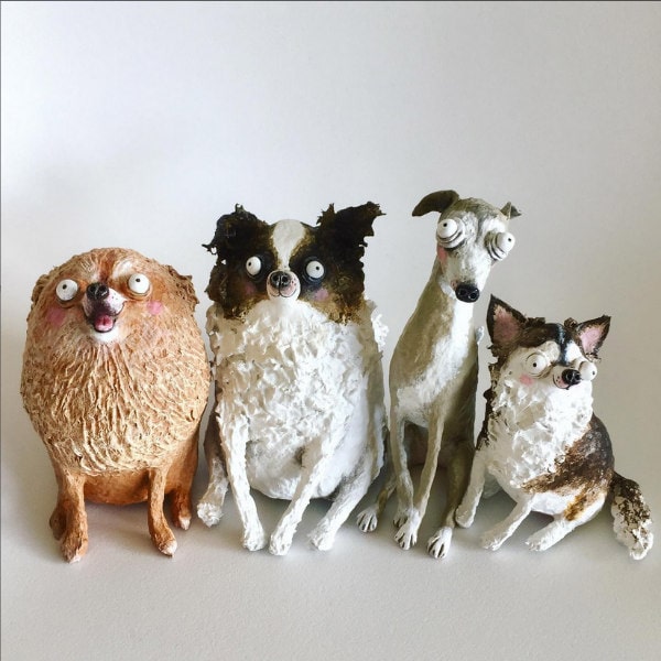 four humorous paper mache dog sculptures with huge eyes