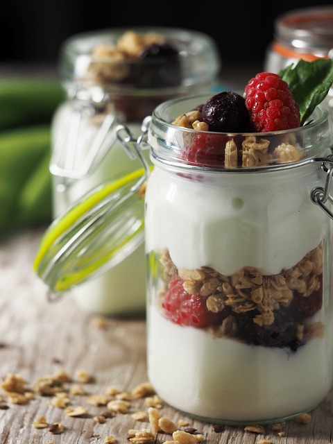 A glass jar with Greek yogurt and berries