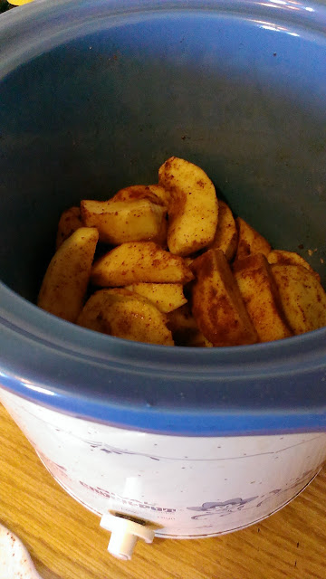 spiced apples in a blue and white crock pot
