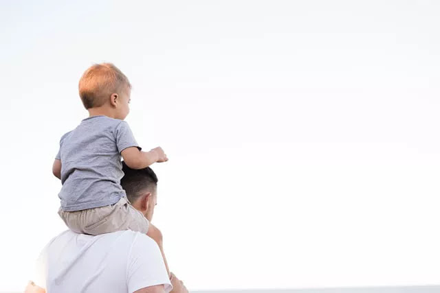 Image of father and a child on his neck